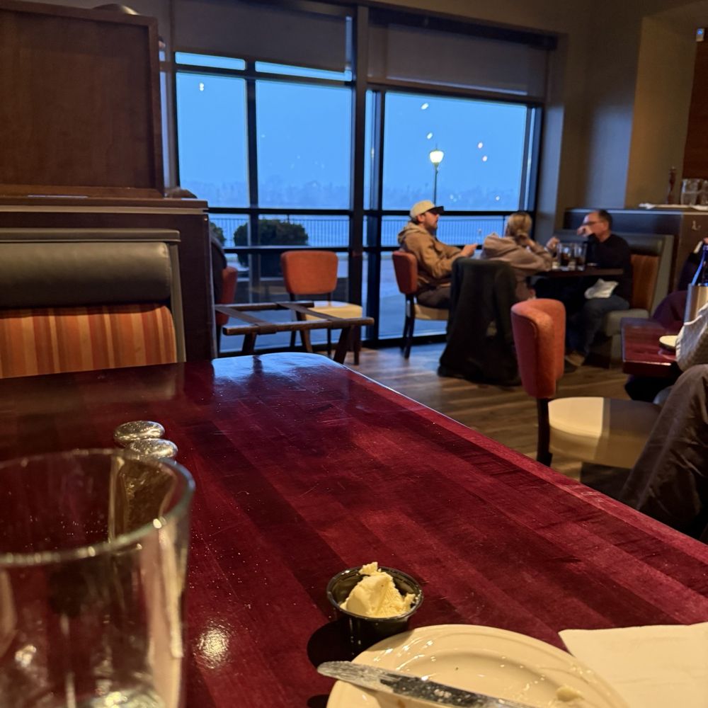 Real Seafood Company Bay City - View from booth showing snow starting over water - Seafood Near Me - Bay City, Michigan Real Seafood Company Bay City - View from booth showing snow starting over water - Seafood Near Me - Bay City, Michigan