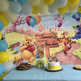 Banner, balloon arch, & cake.