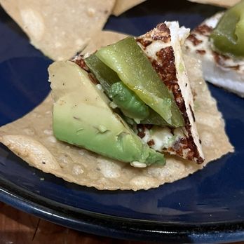 Doneraki - Katy - Jalisco Queso Asado bite on tortilla chip, grilled Mexican cheese, sliced avocado, and sliced jalapeño - Mexican Near Me - Katy, Texas