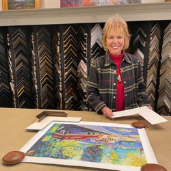 Diane designing the perfect framing to show off a vacation memory.