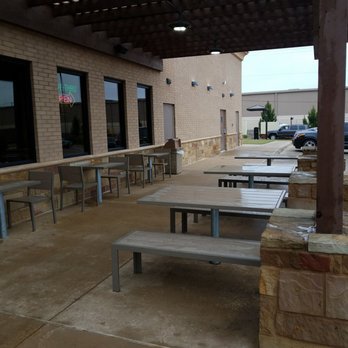 Taco Casa -  tables and benches on a patio - Mexican Near Me - Wichita Falls, Texas