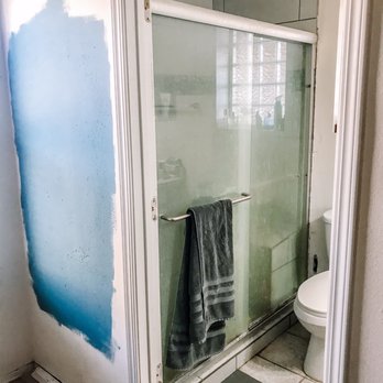 Honey Do - a bathroom with a glass shower door - Landscaping Near Me