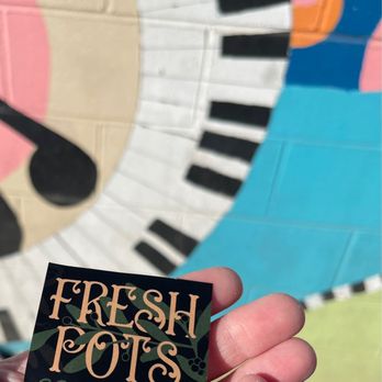 Fresh Pots - a hand holding a coffee bar sign - Coffee & Tea Near Me - Greenwood, Indiana