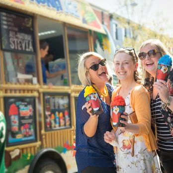Kona Ice Fort Wayne - three women standing in front of a food truck - Caterers Near Me Kona Ice Fort Wayne - three women standing in front of a food truck - Caterers Near Me