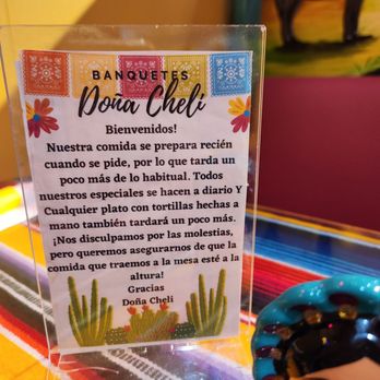 Banquetes Dona Cheli - a mexican doll and a sign - Mexican Near Me - Yonkers, New York