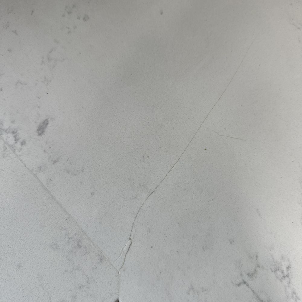 Crack in countertop near seam Crack in countertop near seam