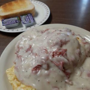 Photo of Mom's Cafe & Catering - Plattsmouth, NE, United States. Omelet wrapped around hashbrowns and smothered in Chipped Beef Gravy.