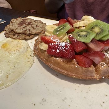 First Watch - Belgian waffle with banana, kiwi and strawberries, fried eggs, and sausage - Breakfast & Brunch Near Me - Charlotte, North Carolina