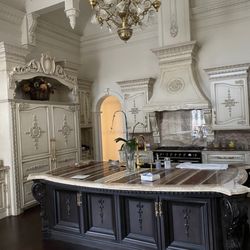 Classic Design Associates - A unique palatial kitchen, featuring exotic onyx countertops and backsplash