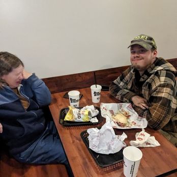Penn Station East Coast Subs - My wife and younger son.  The flinching is NOT from the food!  The flash on the camera stunned my poor wife.Food was happily demolished. - Sandwiches Near Me - Marion, Ohio