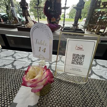 Momi Indian Kitchen - QR code and flower on table - Indian Near Me - Seattle, Washington Momi Indian Kitchen - QR code and flower on table - Indian Near Me - Seattle, Washington