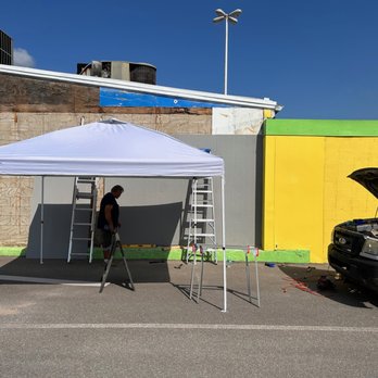 Square One Maintenance - a man standing under a tent - Handyman Near Me Square One Maintenance - a man standing under a tent - Handyman Near Me