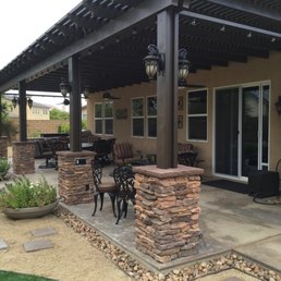 Stone covered awning support pillars and new gravel trim around all concrete by Jorge Reza.