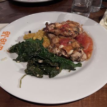 Ulele - Fire Roasted Chicken  Grilled boneless chicken breast, saffron risotto, garlic spinach, vine-ripened tomato garlic lemon basil sauce - New American Near Me - Tampa, Florida
