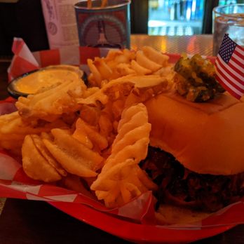 Bub City - Pulled Pork Sandwich with a side of atomic cheese sauce for the waffle fries. - Bars Near Me - Rosemont, Illinois Bub City - Pulled Pork Sandwich with a side of atomic cheese sauce for the waffle fries. - Bars Near Me - Rosemont, Illinois