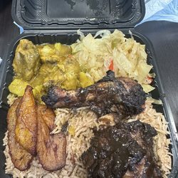 Mix match curry and jerk chicken with rice and beans and 2 sides, cabbage and plantains.