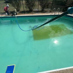 Kelley Clean Pools - Vacuuming yellow algae out.