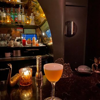 Foreign National - a glass of beer on a bar counter - Cocktail Bars Near Me - Seattle, Washington