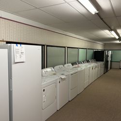 R.A. Ahner Furniture & Appliances - A showroom section featuring an extensive selection of top-loading and front-loading washers and dryers.