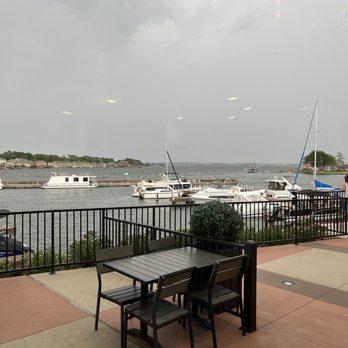 Crust Pizza Co. - Lake Conroe - a table and chairs overlooking a marina - Pizza Near Me - Montgomery, Texas Crust Pizza Co. - Lake Conroe - a table and chairs overlooking a marina - Pizza Near Me - Montgomery, Texas