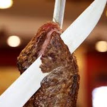 As De Espadas - a piece of meat being held by a knife - Brazilian Near Me - San Antonio, Texas