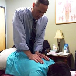 Apponaug Chiropractic Center - Dr. Chris Caliri adjusting a patient