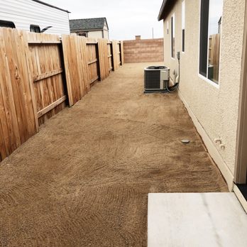 Tiger Concrete and Landscaping - a back yard with a fence and air conditioner - Landscaping Near Me Tiger Concrete and Landscaping - a back yard with a fence and air conditioner - Landscaping Near Me