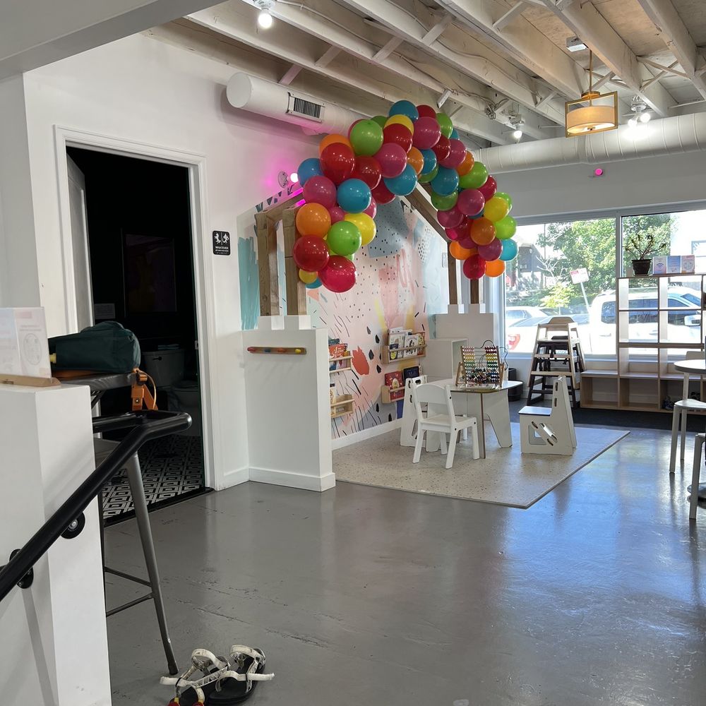 a room with a bunch of balloons hanging from the ceiling a room with a bunch of balloons hanging from the ceiling