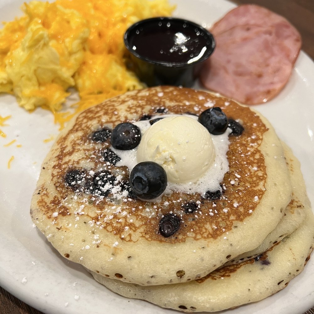 Blueberry's Cafe - a stack of pancakes with blueberries and syrup - Breakfast & Brunch Near Me - Naples, Florida Blueberry's Cafe - a stack of pancakes with blueberries and syrup - Breakfast & Brunch Near Me - Naples, Florida