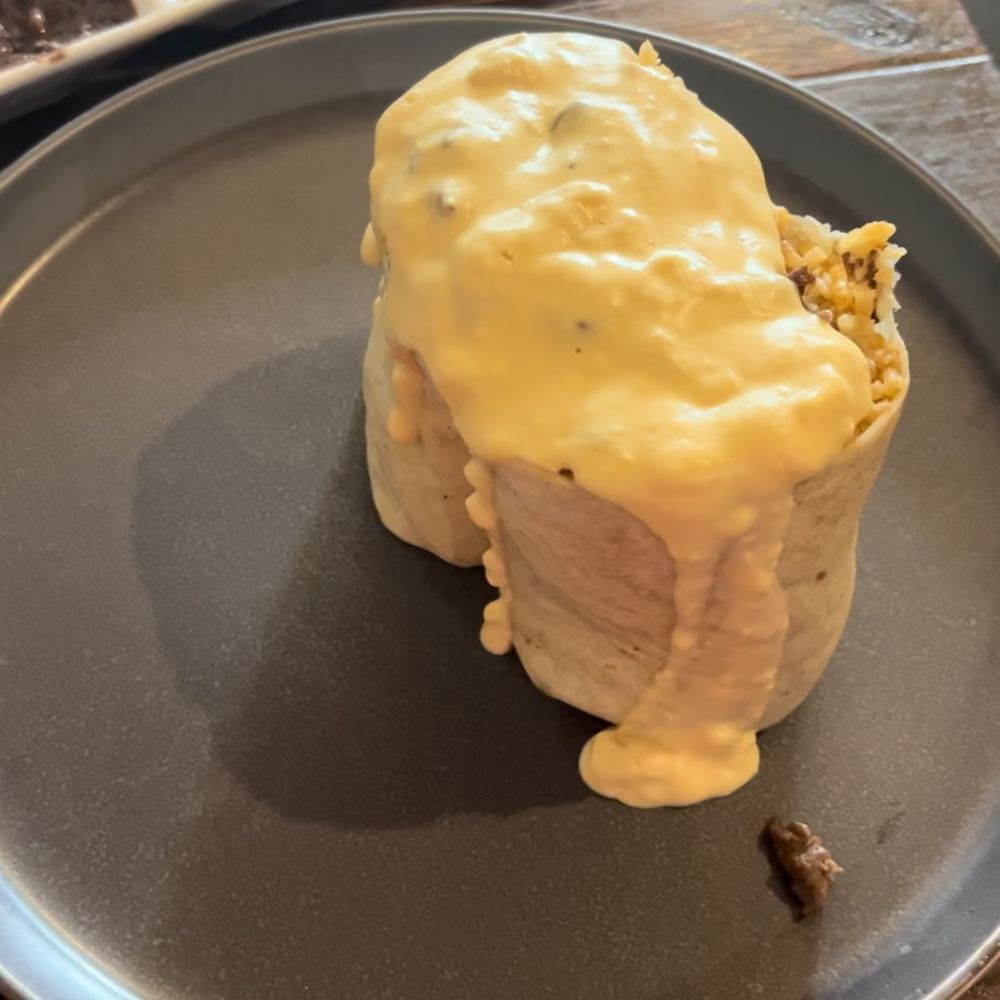 Antojitos Mexicanos - Open face burrito topped with queso - Mexican Near Me - Appleton, Wisconsin