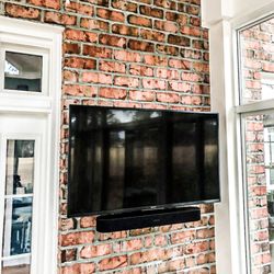 Connected Home - TV Mounted on Brick in Sunroom