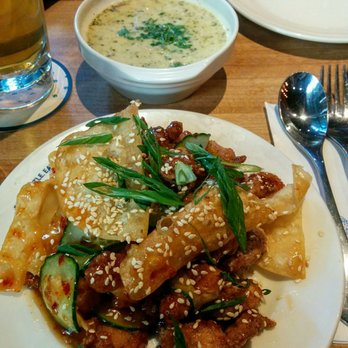 Earls Kitchen + Bar - Chili Chicken + Wontons and Earls Famous Clam Chowder in the background - Canadian (New) Near Me - Toronto, Ontario Earls Kitchen + Bar - Chili Chicken + Wontons and Earls Famous Clam Chowder in the background - Canadian (New) Near Me - Toronto, Ontario