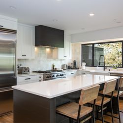 Mayacamas Design - Modern Kitchen: A sleek kitchen design with high-end appliances, contrasting cabinets, and a large island for cooking and entertaining.