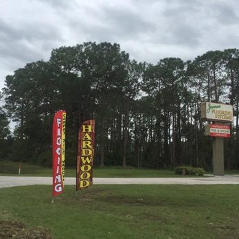 James Flooring - a parking lot with a lot of signs - Carpeting Near Me - St. Augustine, Florida