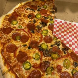 Pizza with mushrooms, pepperonis, and jalapeños.