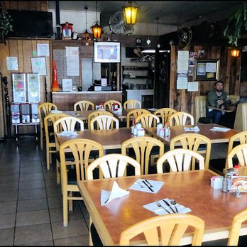El Puerto Restaurant - The dining room, as you enter, with the counter, and the window to the kitchen in the rear. - Mexican Near Me - Rancho Cordova, California El Puerto Restaurant - The dining room, as you enter, with the counter, and the window to the kitchen in the rear. - Mexican Near Me - Rancho Cordova, California