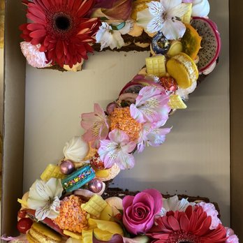 Astoria Cafe & Bakery - Geneva  - Chocolate cake with a strawberry filling. Notice the macrons, candies, and fresh fruit as well as the beautiful flowers!! - Desserts Near Me - Geneva, Illinois