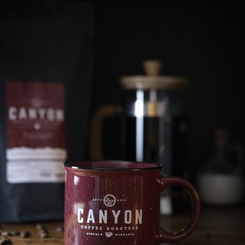 Canyon Coffee Roasters - a coffee bag and a coffee mug - Coffee Roasteries Near Me - Lincoln, Nebraska Canyon Coffee Roasters - a coffee bag and a coffee mug - Coffee Roasteries Near Me - Lincoln, Nebraska