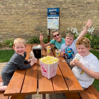 Snack Shack of Waterville - a family sitting at a picnic table - Popcorn Shops Near Me - Waterville, Minnesota Snack Shack of Waterville - a family sitting at a picnic table - Popcorn Shops Near Me - Waterville, Minnesota