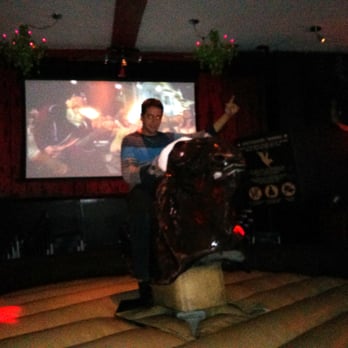 Chez Serge - a man standing in front of a large screen - Sports Bars Near Me - Montreal, Quebec Chez Serge - a man standing in front of a large screen - Sports Bars Near Me - Montreal, Quebec