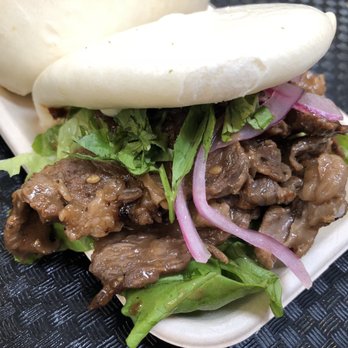 Madbun - De La Seoul - Beef bulgogi with ssamjang, yuzu sesame sauce, pickled onion, green leaf lettuce, and cilantro in a steamed bun - Asian Fusion Near Me - Rancho Cucamonga, California Madbun - De La Seoul - Beef bulgogi with ssamjang, yuzu sesame sauce, pickled onion, green leaf lettuce, and cilantro in a steamed bun - Asian Fusion Near Me - Rancho Cucamonga, California