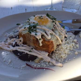 Licha's Cantina - Pastel Azteca with fried black beans, queso fresco, and topped with a friend egg! Really good!! - Bars Near Me - Austin, Texas Licha's Cantina - Pastel Azteca with fried black beans, queso fresco, and topped with a friend egg! Really good!! - Bars Near Me - Austin, Texas