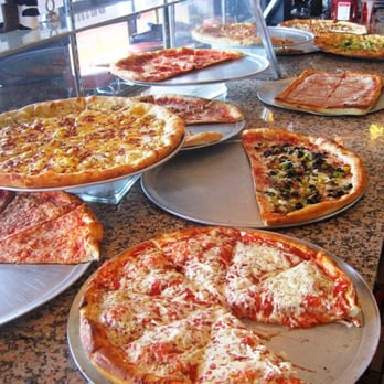 Pizza Central - a variety of pizzas on a counter - Pizza Near Me - Albany, New York Pizza Central - a variety of pizzas on a counter - Pizza Near Me - Albany, New York