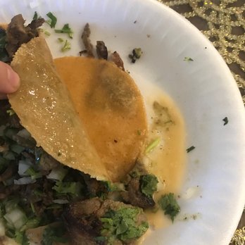 Tijuana's Tacos - a hand holding a tortilla - Mexican Near Me - Riverside, California Tijuana's Tacos - a hand holding a tortilla - Mexican Near Me - Riverside, California