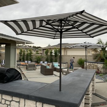 Gang Green Landscaping - a patio with a grill and umbrella - Landscaping Near Me Gang Green Landscaping - a patio with a grill and umbrella - Landscaping Near Me