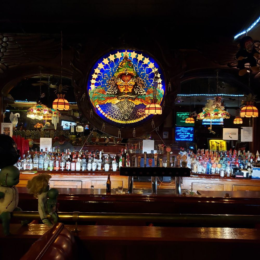 a bar with a stained glass window a bar with a stained glass window