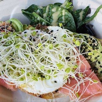 Pau Bakery - Smoked salmon, sprouts, over easy egg, black sesame, avocado on sourdough toast. Spinach w/mustard-vinaigrette dressing. - Bakeries Near Me - Lahaina, Hawaii