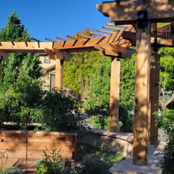 Cedar & Soil Artisan Landscapes - Custom pergola atop a seat wall with raised vegetable planter and step stones