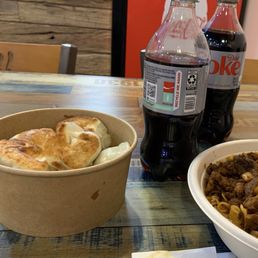 Dumplings next to 20oz. Bottle to show generous portion size