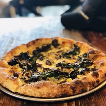Cafe Crema - a pizza on a plate on a table - Coffee & Tea Near Me - West Vancouver, British Columbia Cafe Crema - a pizza on a plate on a table - Coffee & Tea Near Me - West Vancouver, British Columbia